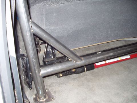 1993 Ford Bronco - Close-up view of a custom roll cage installed in the interior of a vehicle.