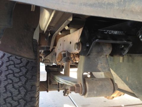 1994 Ford Bronco - This image shows the underside of a vehicle, focusing on the suspension system and leaf springs.