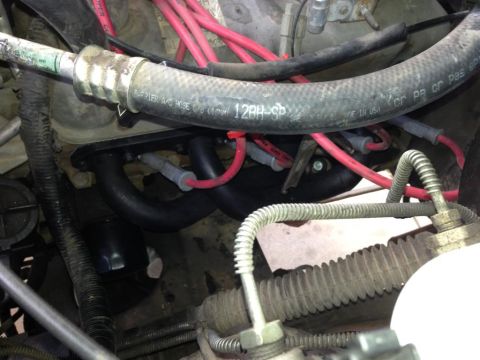 1994 Ford Bronco - Close-up view of engine components including spark plug wires and hoses.