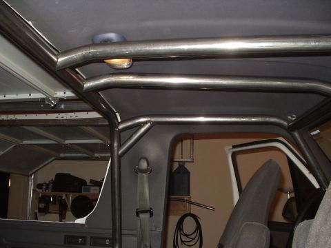 1993 Ford Bronco - Custom roll cage installed in a vehicle's interior, obscuring most of the original cabin features.
