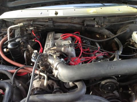 1994 Ford Bronco - Engine bay details including red spark plug wires and a K&N air intake system.
