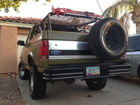 1994 Ford Bronco - This modified Ford Bronco features a rear-mounted spare tire and a roof-mounted jack.