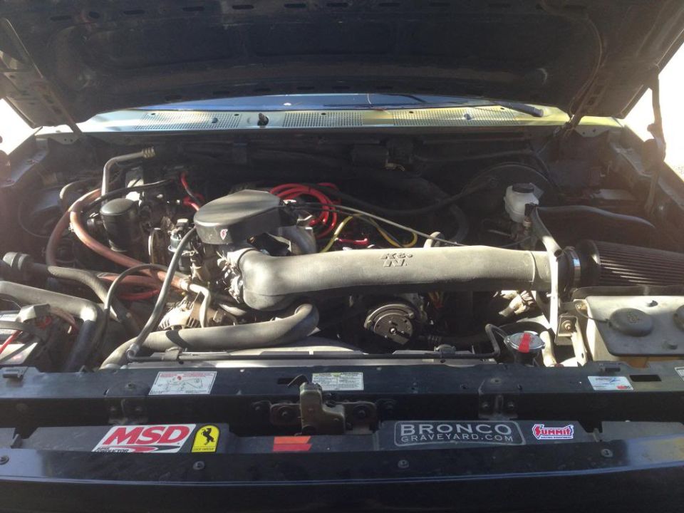 1994 Ford Bronco engine bay with MSD and Bronco Graveyard stickers on the radiator support