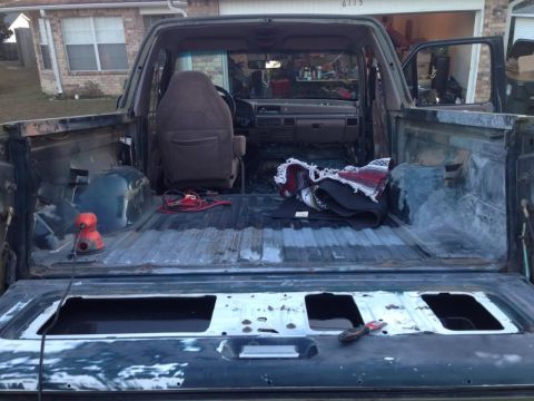 1994 Ford Bronco - The interior and cargo bed of a Ford Bronco are visible, with tools suggesting ongoing work.