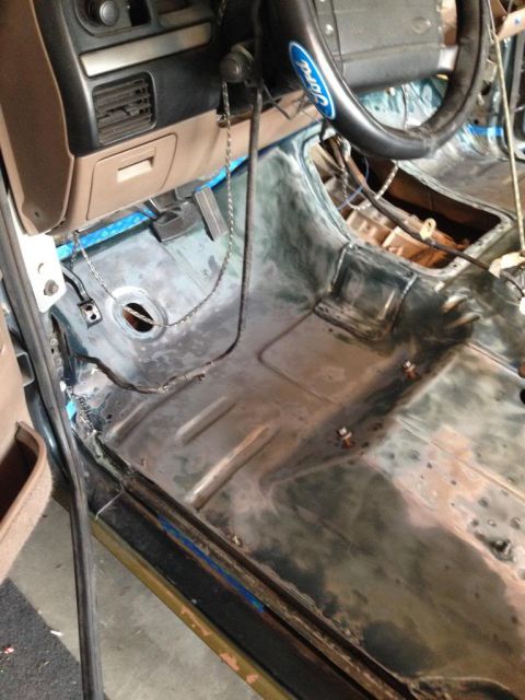 1994 Ford Bronco - Interior of a 1994 Ford Bronco during restoration, with the floor stripped bare.
