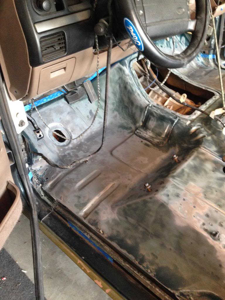 1994 Ford Bronco interior showing bare metal floor and dashboard