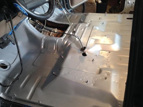 1994 Ford Bronco - The interior floor pan of a 1994 Ford Bronco is visible, prepped for sound deadening.