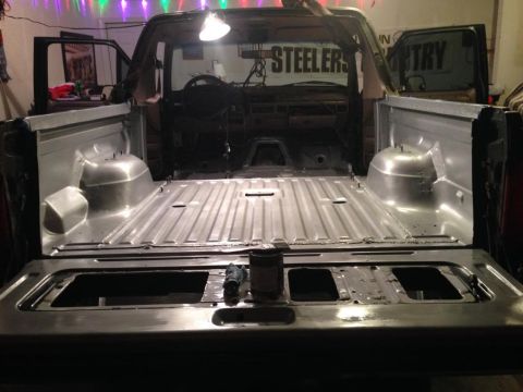 1994 Ford Bronco - The interior of a Ford Bronco is shown with its bed empty and ready for work.
