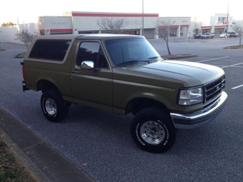 1994 Ford Bronco - This 1994 Ford Bronco is seen in a parking lot, likely a daily driver or a vehicle ready for adventure.