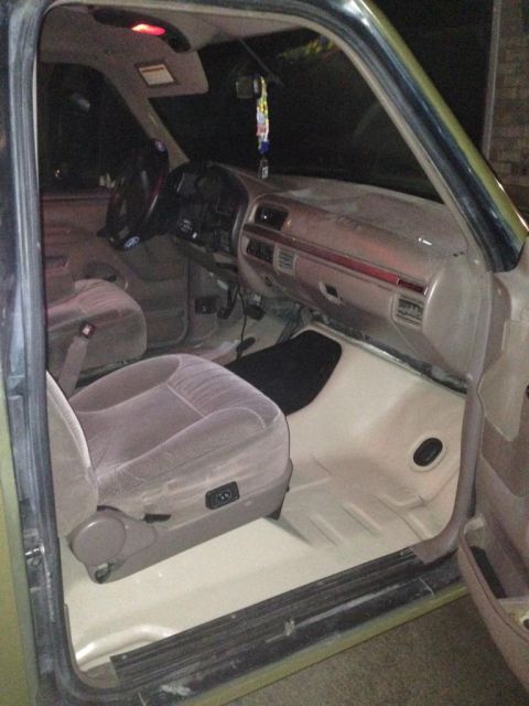 1994 Ford Bronco - The interior of a truck, likely from the 1990s, is viewed from the passenger side door.