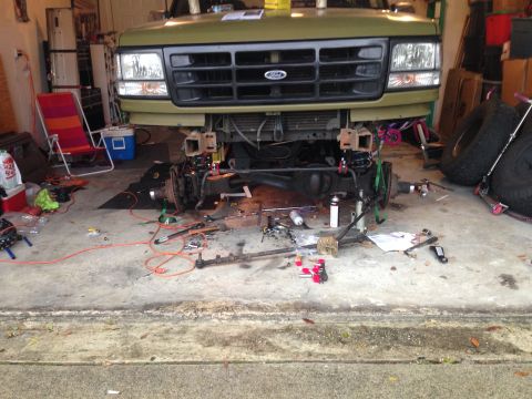 1994 Ford Bronco - The front suspension and steering components of a Ford Bronco are removed for maintenance or repair.