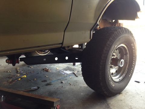 1994 Ford Bronco - A lifted 1992 Ford Bronco is shown from the side, with its suspension and large tire clearly visible.