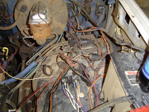 1989 Ford Bronco - A complex web of wires and components fills the engine bay, obscuring the vehicle's specific model and year.