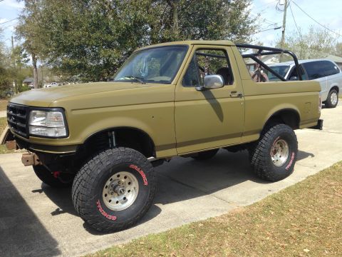1994 Ford Bronco - This modified Ford Bronco features an aggressive stance and off-road tires, suggesting it's built for terrain.