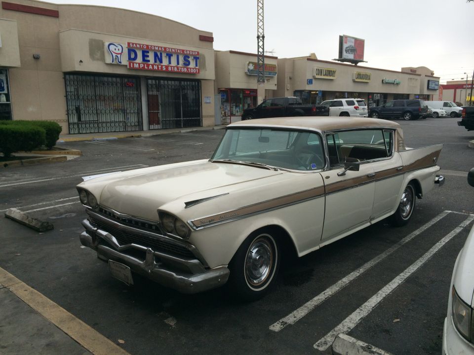 Cream and tan 1958 Studebaker President sedan parked in a lot, front 3/4 view