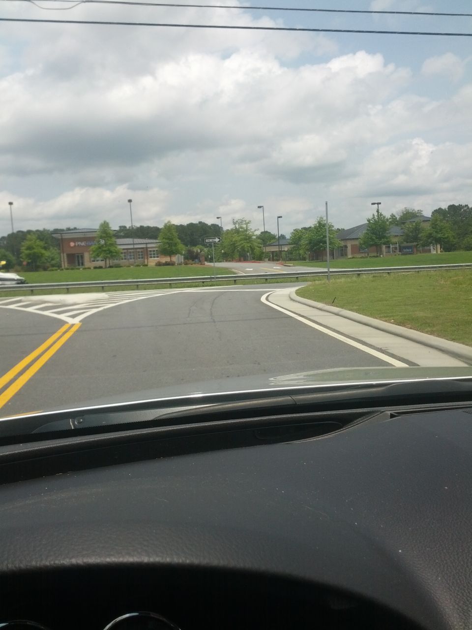 Roadway intersection with buildings in background