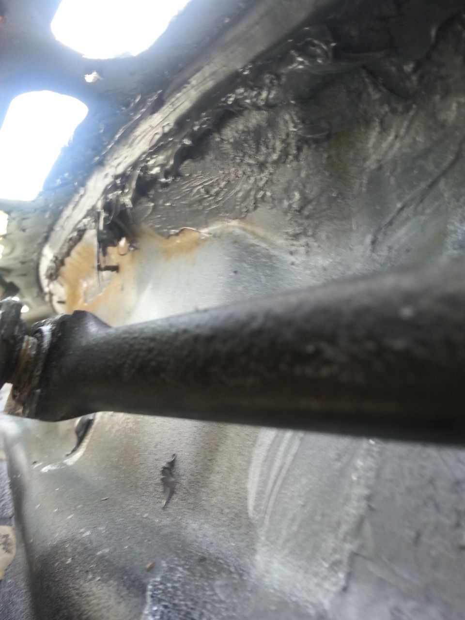 This is a picture from inside of the trough. In addition to applying the seam sealer along the seam at the top, I ran another coating across the bottom. At the far left of the picture you can also see a metal screw sticking through the firewall. I'm not sure if water could have been leaking there, but I covered that up as well.