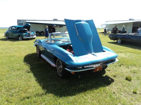 2004 Mercury Grand Marquis - A classic blue Corvette Sting Ray convertible is displayed with its hood open at an outdoor car show.