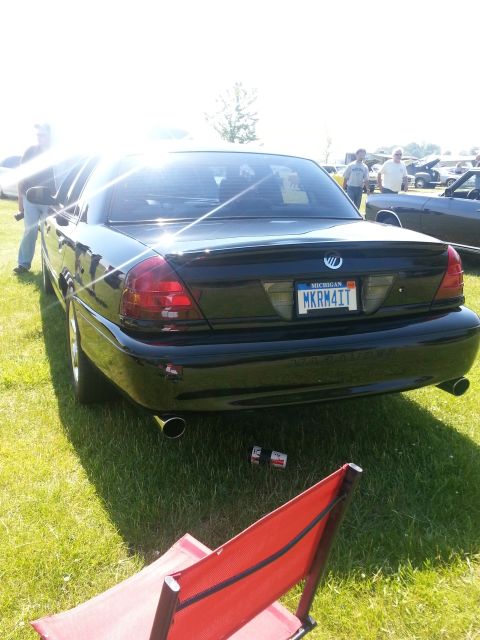 2004 Mercury Grand Marquis - Rear view of a black sedan with dual exhaust pipes and a spoiler.