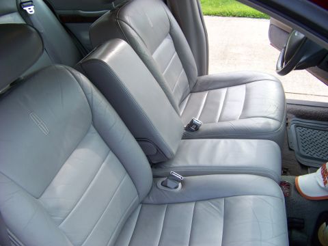 1999 Mercury Grand Marquis - Interior view of car seats, showing the upholstery and seat belt mechanisms.