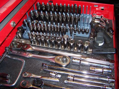 1995 Mercury Grand Marquis - Close-up of a mechanic's tool chest drawer containing a variety of sockets and wrenches.