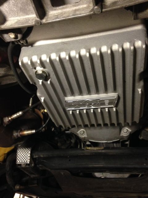 2010 Dodge Challenger - Close-up view of a transmission pan with a prominent 'Magna' logo, likely an aftermarket part.