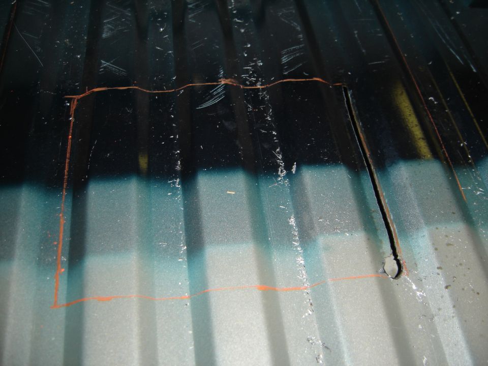 Truck bed with orange markings and a cut-out hole