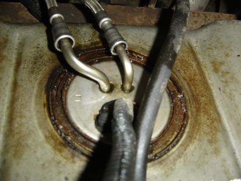 1996 Ford Bronco - Close-up view of a vehicle's fuel pump assembly, highlighting its components and condition.