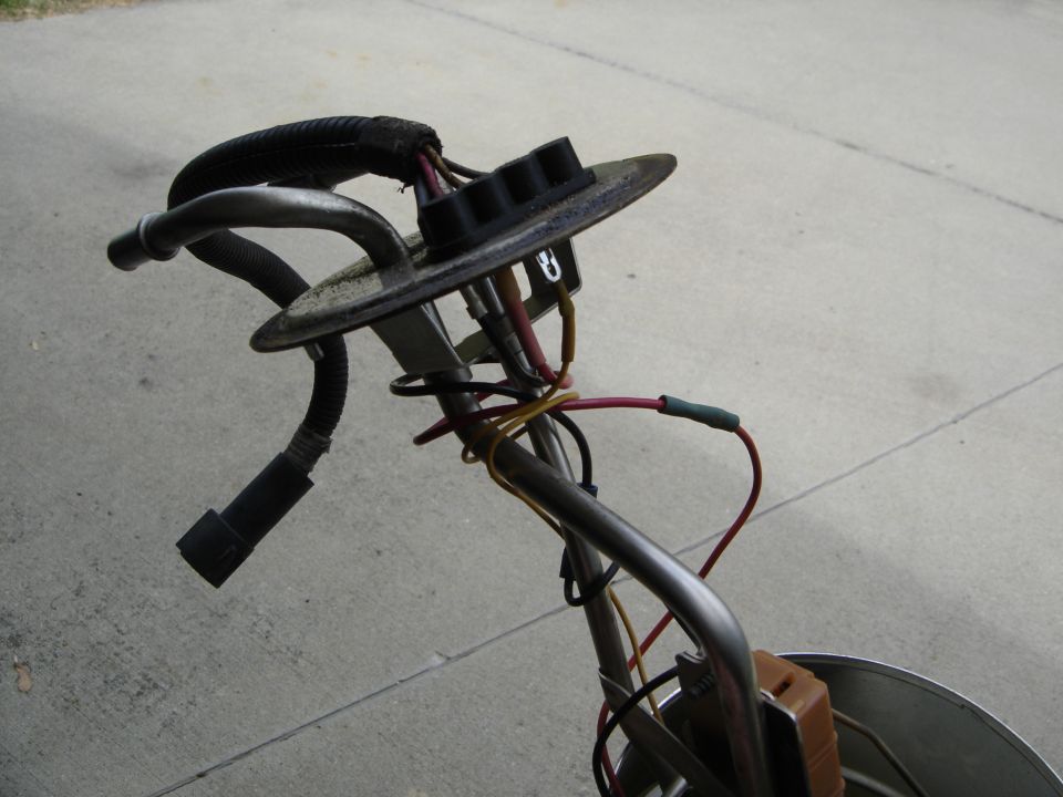 Fuel pump assembly with wires and hoses. Supermotors.net logo visible