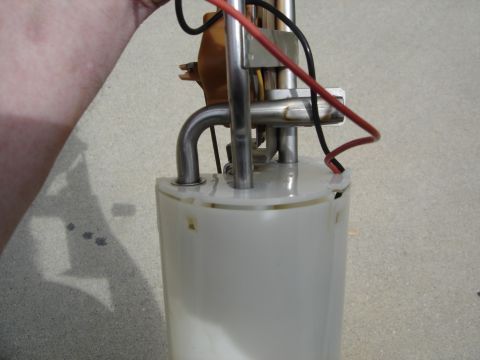 1996 Ford Bronco - A fuel pump assembly is shown with metal lines and electrical wires connected to the top.