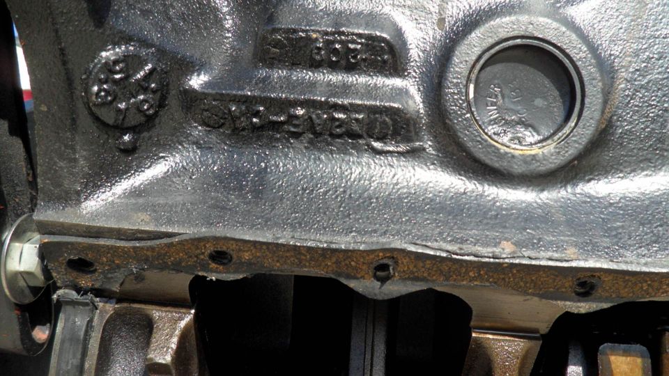 Close-up of a cast iron engine block with part numbers visible