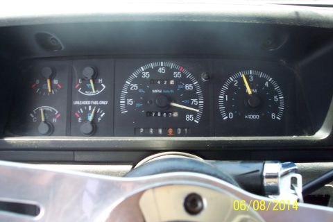 1990 Ford Bronco - The dashboard gauges show the speedometer at 70 mph and the tachometer at 2000 RPM.