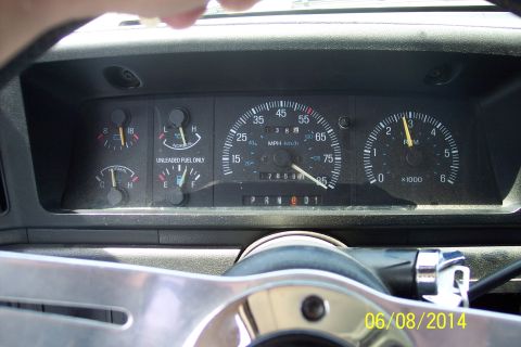 1990 Ford Bronco - Interior view of a 1990 Ford Bronco dashboard showing various gauges and the odometer reading.