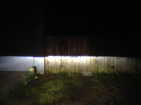 1992 Ford F-150 - Headlights illuminate a fence and garage door at night, with the Supermotors.net logo in the corner.
