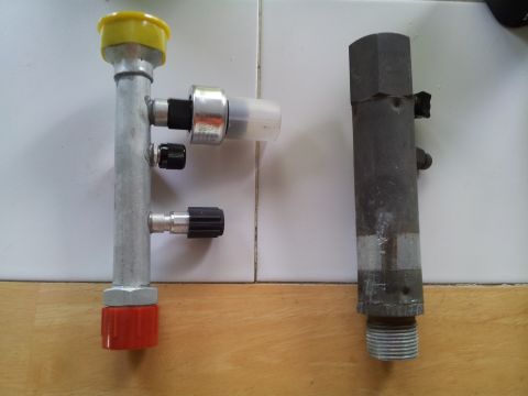 1976 Ford Ranchero - Close-up view of two automotive air conditioning service valves, likely for refrigerant charging or recovery.