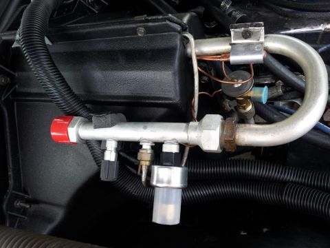 1976 Ford Ranchero - Detail of air conditioning system components, including lines, a valve, and a pressure sensor.