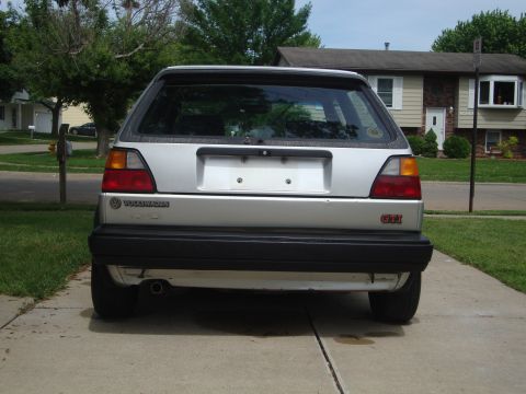 1985 Volkswagen GTI - Rear view of a silver 1985 Volkswagen GTI parked in a driveway.