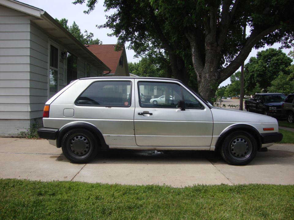 Side view of a silver 1985 Volkswagen GTI parked on a driveway