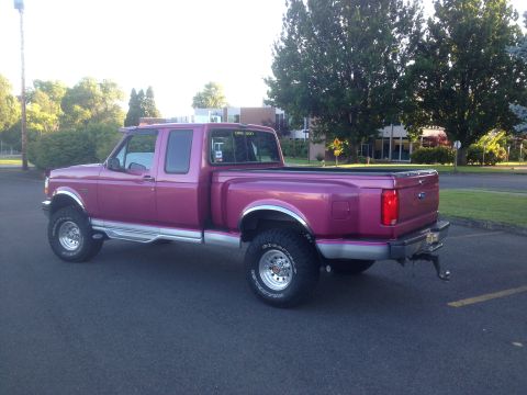 1992 Ford F-150 - This 1992 Ford F-150 pickup truck is shown in a rear 3/4 view, a vibrant purple paint job.