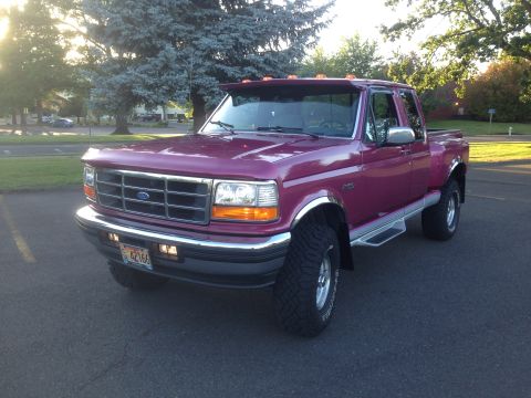 1992 Ford F-150 - This purple Ford F-150 pickup truck is shown from a three-quarter front view.