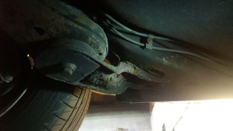 1994 Ford Thunderbird - The underbody of the vehicle displays severe rust damage, particularly on the frame and suspension parts.