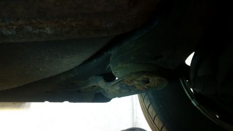 1994 Ford Thunderbird - Undercarriage shows signs of rust and repair work on suspension components.