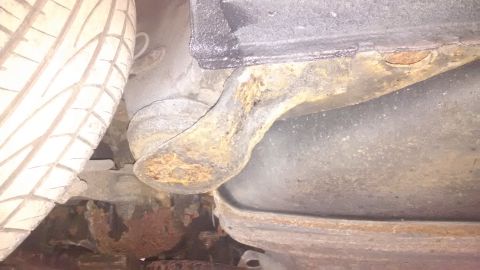 1994 Ford Thunderbird - The undercarriage shows extensive rust and corrosion on various parts, indicating poor condition.