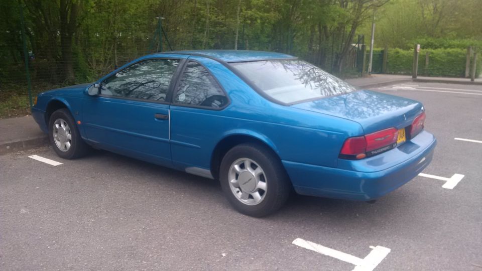 Blue 1994 Ford Thunderbird parked in a lot, rear view