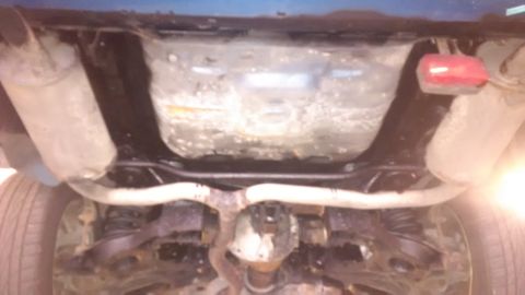 1994 Ford Thunderbird - The underside of a vehicle, with visible exhaust pipes and fuel tank, is shown.