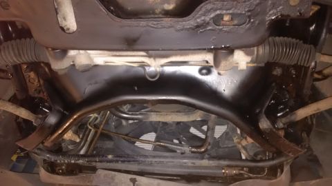 1994 Ford Thunderbird - Underside view of vehicle's front suspension and steering components, showing rust and undercoating.