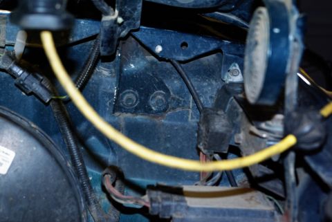 1995 Ford Bronco - Detail of engine bay wiring and components, showing a yellow wire and various connectors.