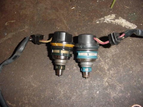 1992 Ford Bronco - Two fuel injectors are shown, one with a yellow band and the other with a blue band, connected to wiring.