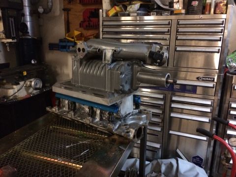 1996 Ford Bronco - A supercharger assembly is mounted on an engine block, likely in a workshop setting.