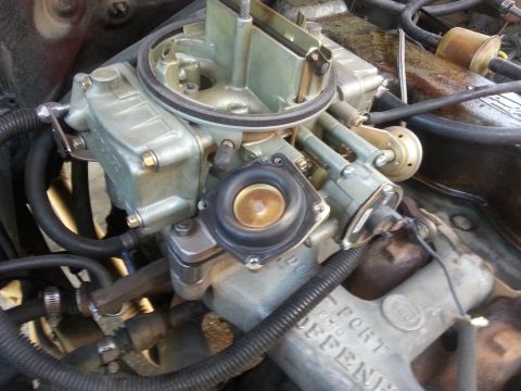 1981 Ford Bronco - Close-up of a carburetor, a critical engine component for fuel delivery.